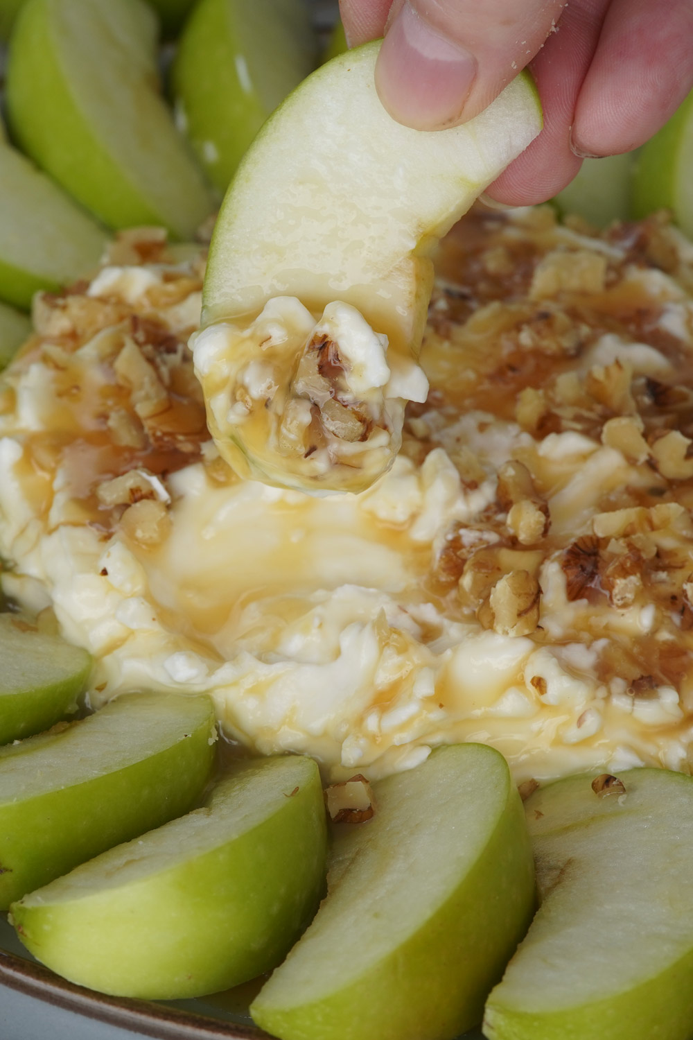 Caramel apple dip with a circle of green apples around it