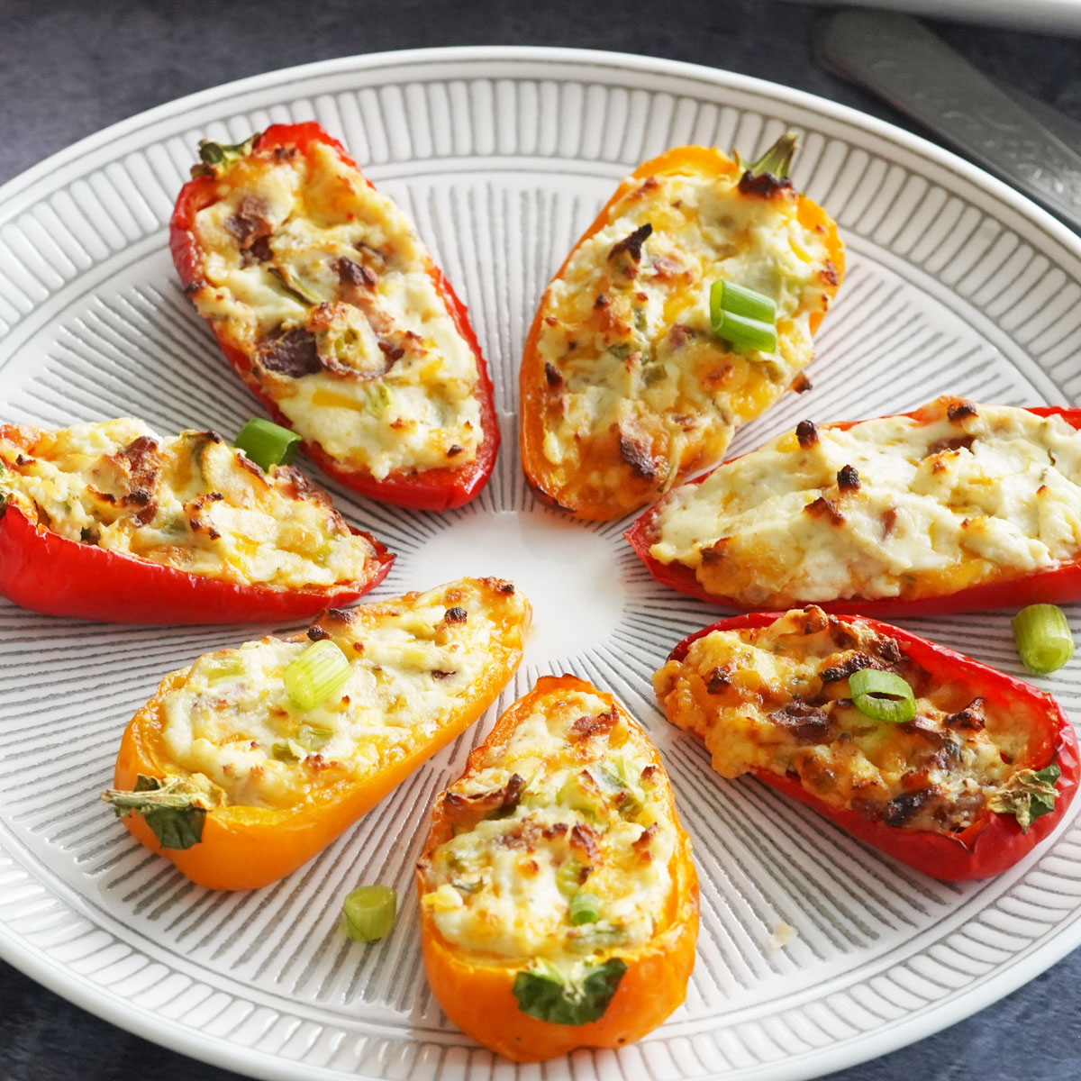 Cream cheese stuffed peppers on a platter
