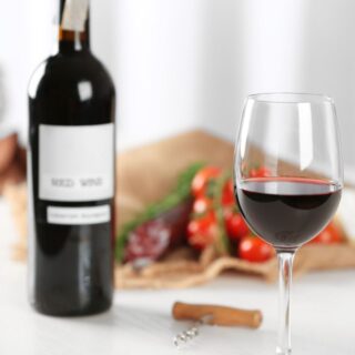 A bottle of wine and a glass
