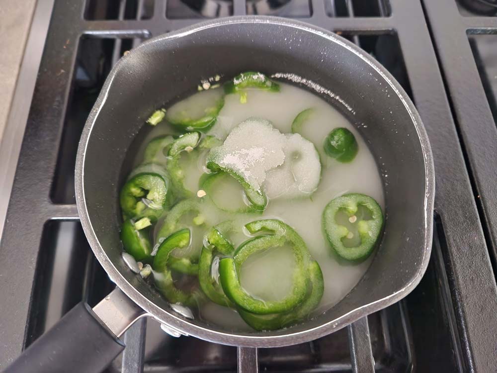 Cooking the ingredients for jalapeno simple syrup
