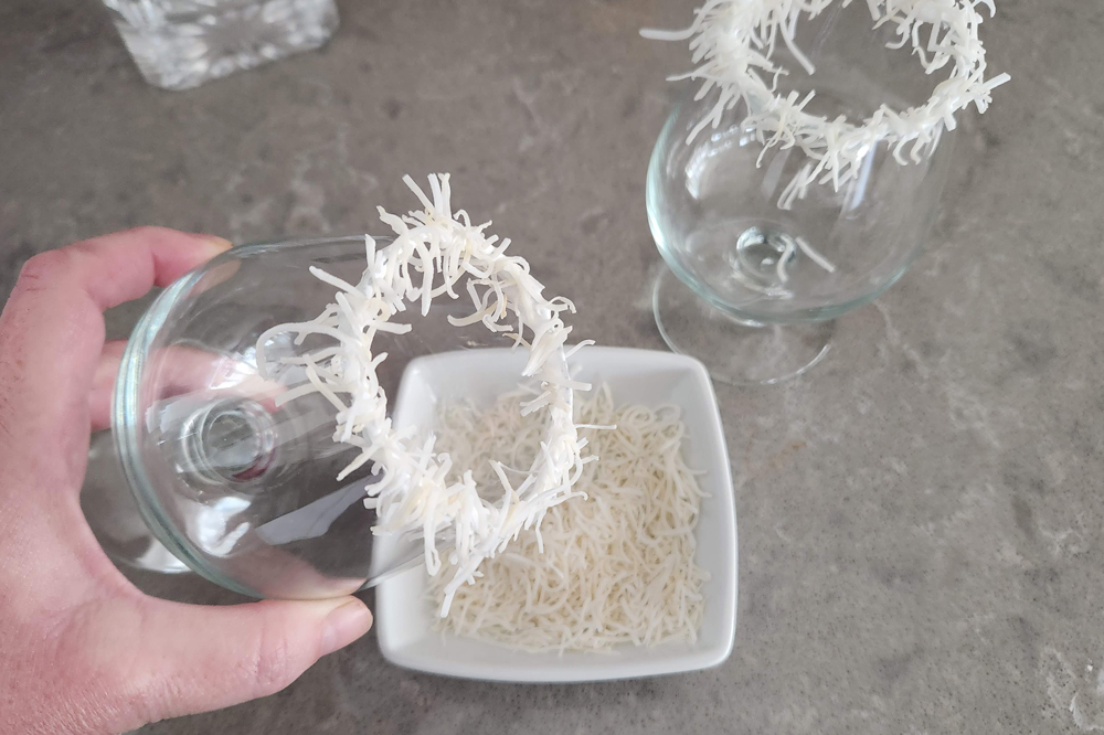 Rimming the glass with marshmallow fluff and coconut