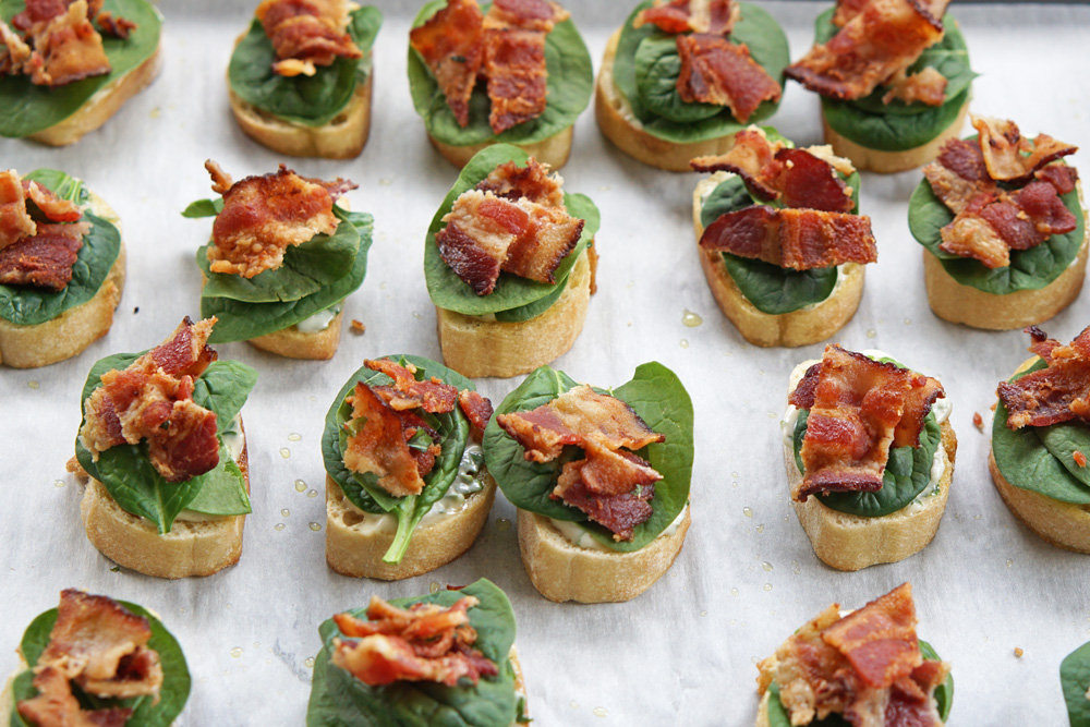 adding spinach and bacon to the bread