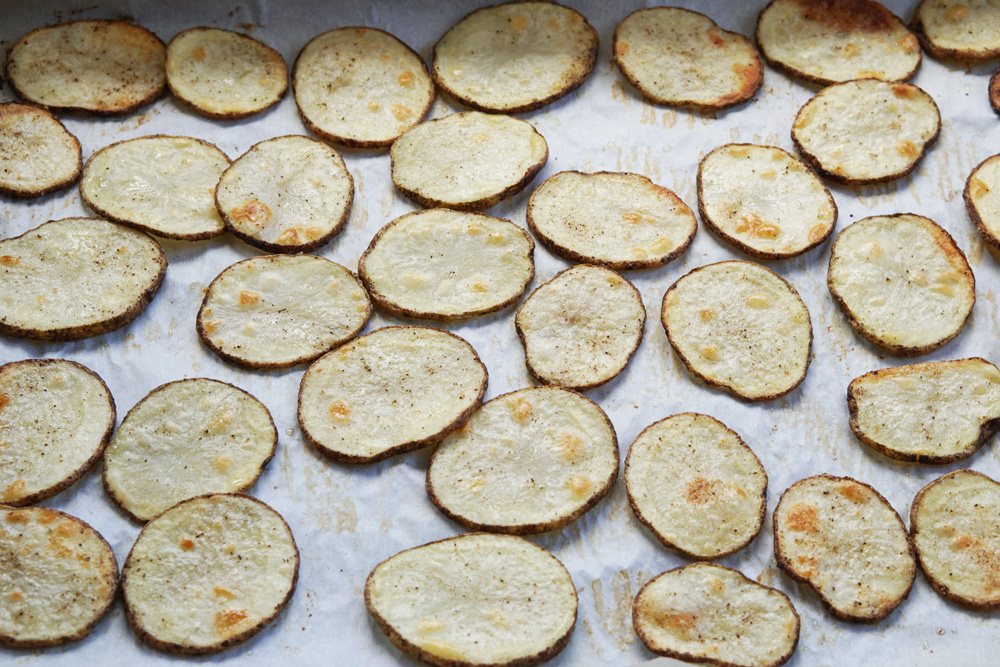 cooked potato rounds on a baking sheet