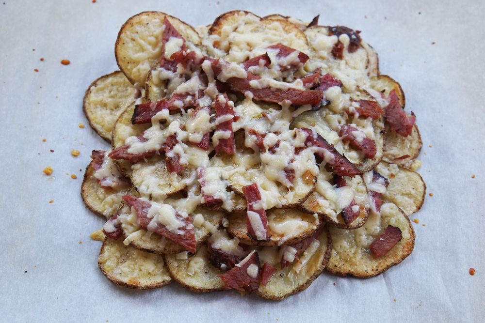 Potato rounds with corned beef and cheese melted